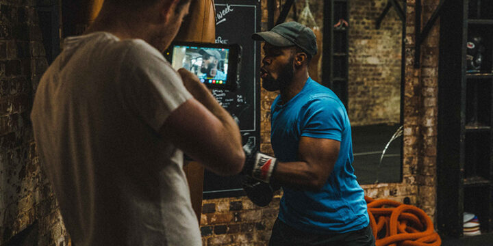 Athlete punching sand bag